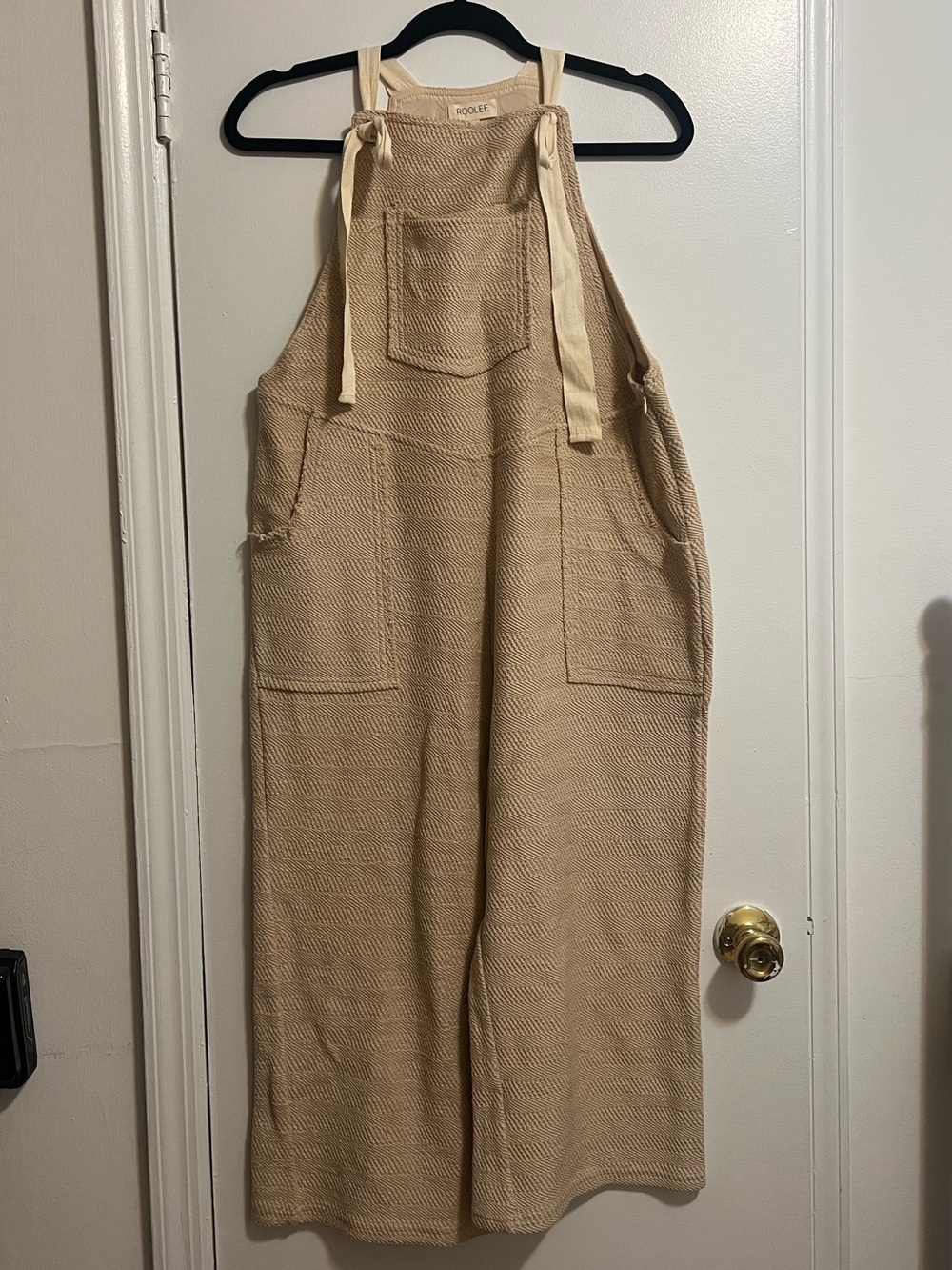 Knit overalls with tie straps and front and back pockets